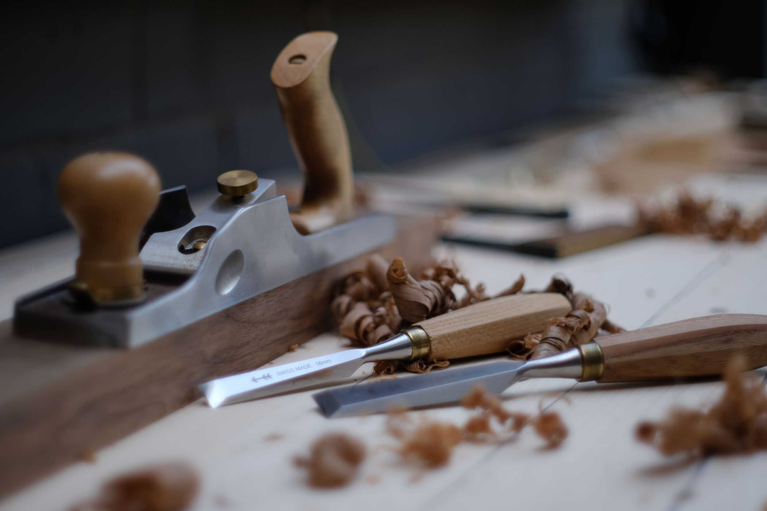 Close-up view of woodworking tools and wood shavings