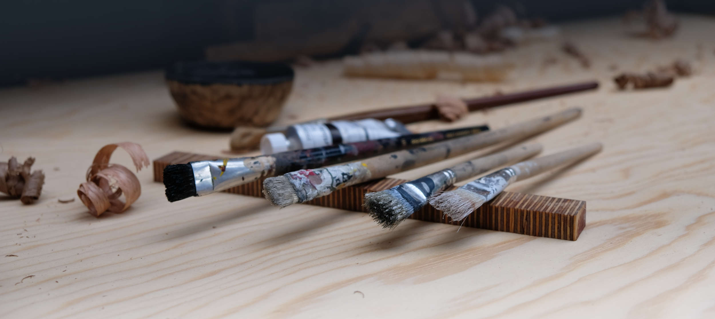 Paintbrushes and acrylic paint in a workshop